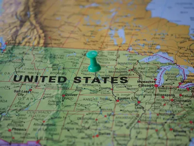 A map of the United States with state licensing agency logos representing small residential care home regulation
