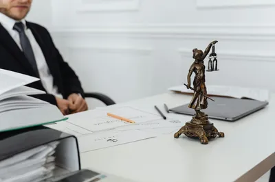 An older couple reviewing documents with a professional across a wooden desk
