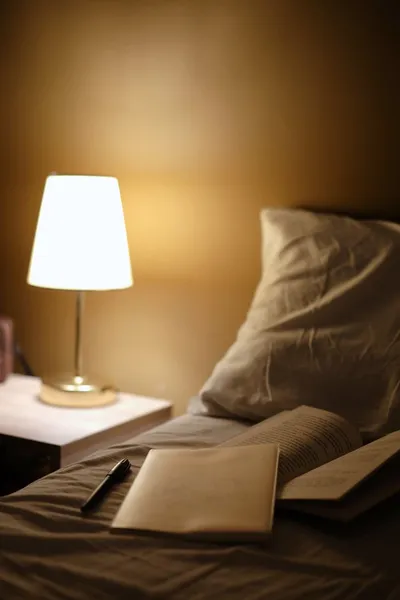 A softly lit hallway in a small residential home at night with a warm nightlight near the floor.