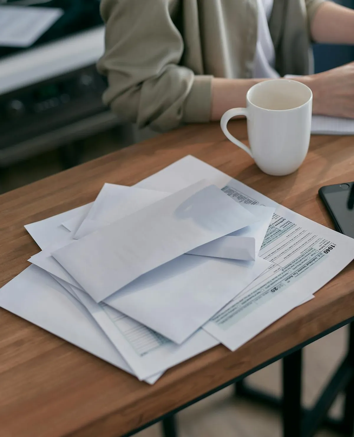 A tax form, a calculator, and a folder labeled medical expenses on a wooden desk.
