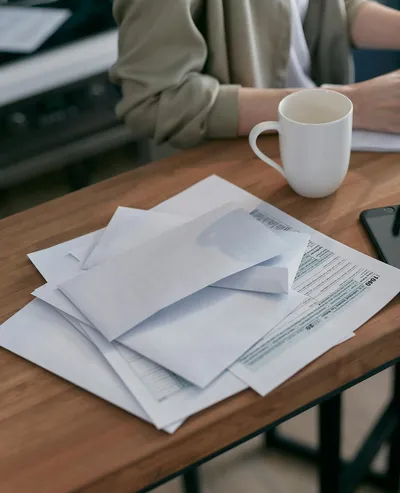 A tax form, a calculator, and a folder labeled medical expenses on a wooden desk.
